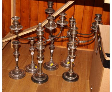 A pair of silver plate candelabra, another candelabrum and three candlesticks