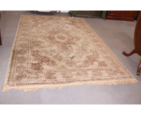 A Persian design carpet decorated central medallion and spandrels on a beige ground with border, 113" x 38" approx