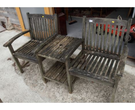 A slatted teak double garden seat with central table