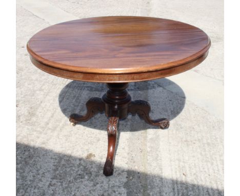 A 19th Century circular mahogany tilt top dining table, on leaf carved tripod base, 40" dia