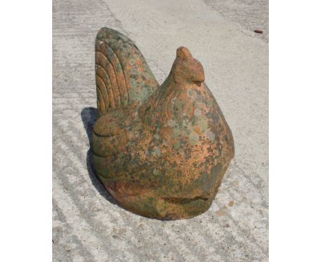 A weathered terracotta garden ornament of a hen, 13" high
