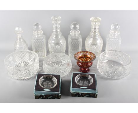 A set of three square glass spirit decanters, a pair of 19th Century decanters decorated diamond and panel cutting, a similar