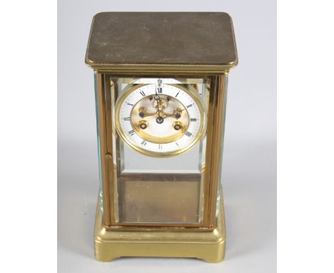 A 19th Century brass cased four-glass clock with white enamel dial and striking movement, 10 1/2" high