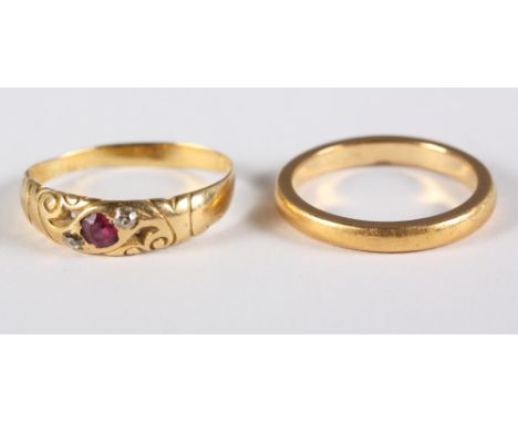 An unmarked yellow metal ruby and diamond set ring and a similar wedding band, 5.7g