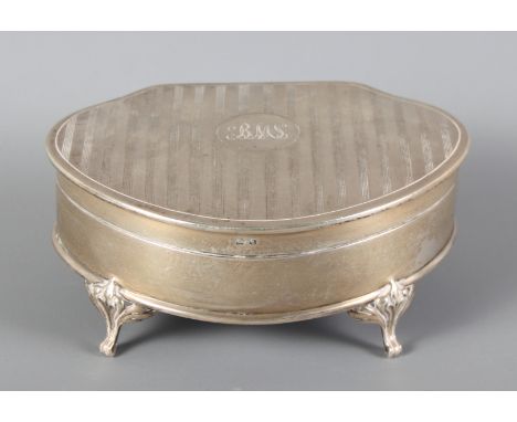 A silver ring box with engine turned decoration