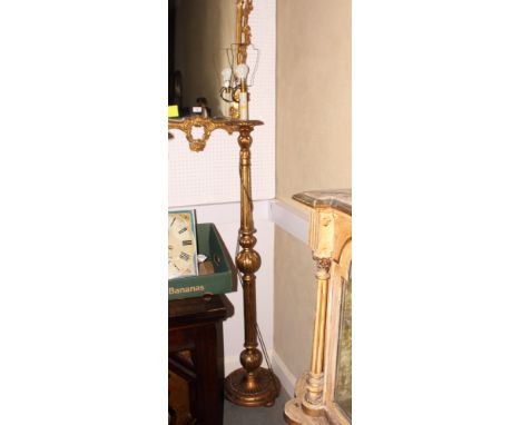 A giltwood standard lamp, on circular base