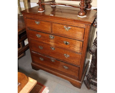 A 19th Century oak chest of two short and three long drawers with brass handles, on bracket supports, 39" wide