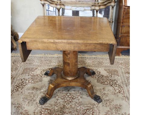 A 19th Century oak sofa table, fitted frieze drawer, on plain turned central stem and platform base with ebonised paw termina