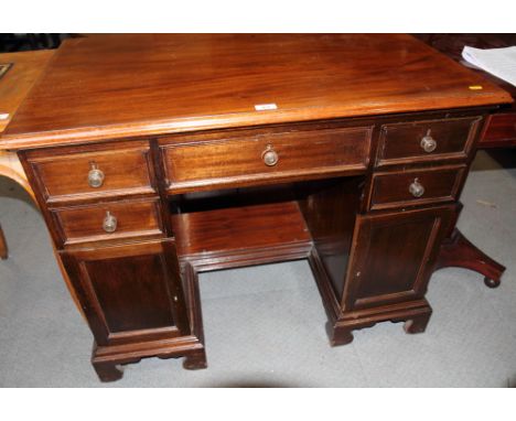 A 19th Century mahogany twin pedestal writing table, fitted five drawers and two cupboards, on bracket supports, 28" wide