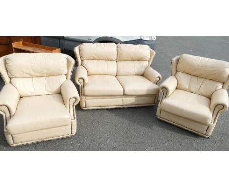 Three piece leather suite comprising of two armchairs and a two seater sofa in cream leather 