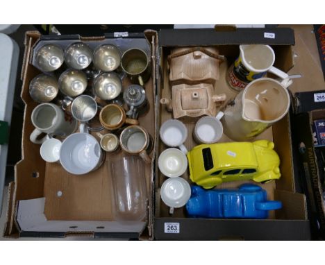 A mixed collection of ceramic and metalware items to include goblets, tankards, novelty ceramic money boxes, advertising wate