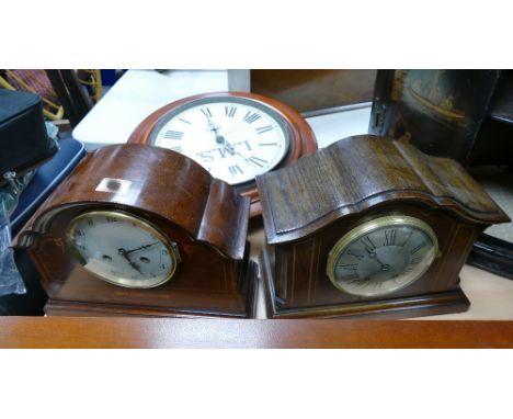 A LMS railway clock with oak and mahogany inlaid mantle clocks. (3)