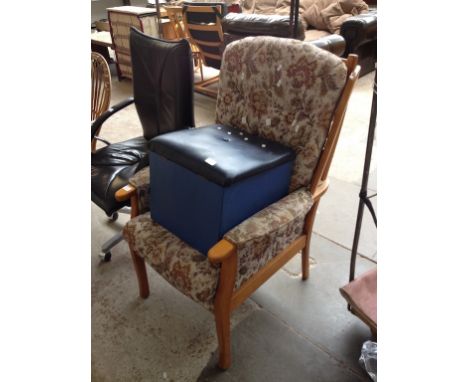 A FLORAL UPHOLSTERED WOOD SHOW ARMCHAIR AND A POUFFE