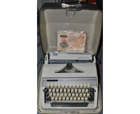 A cream Adler typewriter with case and instruction booklet, Model: Gabrielle 25