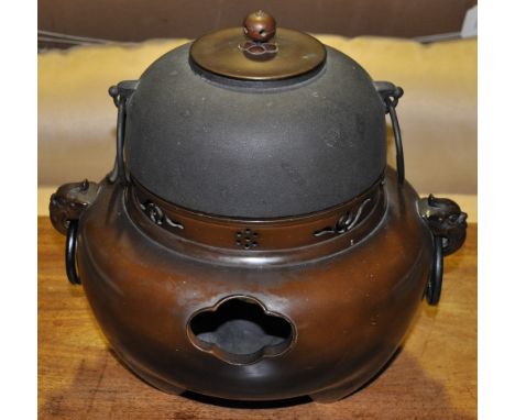 A Japanese bronzed burner with a cast iron water pot and cover with a berry shaped finial (Height approx 33cm)