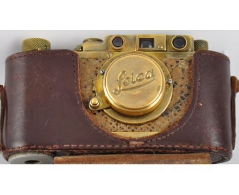 A vintage Leica-style faux snakeskin bound brass camera, with tan leather case