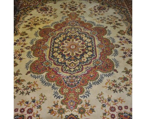 An Chinese pale green ground carpet woven with a central floral panel, together with a Persian style machined carpet