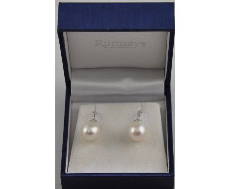 A pair of 18ct white gold diamond and pearl drop earrings