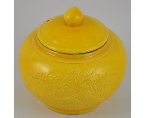 A small Chinese ginger jar with a yellow glaze and a finial on the lid, bears six character Qianling style mark to base