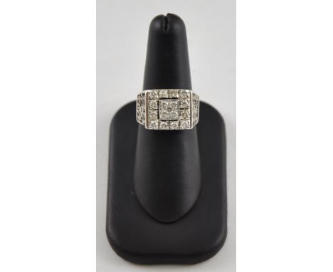 An Art Deco style diamond cluster ring in a white metal band with pierced shoulder, the diamond approx 1ct