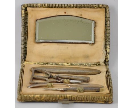 An Art Deco 800 standard silver part manicure set in faux lizard case, and Mappin & Webb silver butter knife