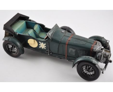 A vintage-style tinplate model car in British racing green livery, L. 40cm
