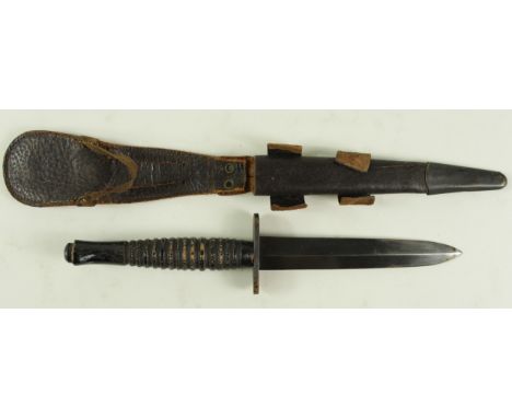 Knife: An ummarked F.S. fighting knife. Ribbed wooden grip. Shortened blade 5.25". In its leather scabbard with brass chape. 