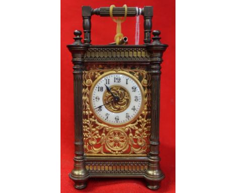 A late 19th century carriage clock, decorative brass four column case with bale handle, the dial with Arabic numerals, overal