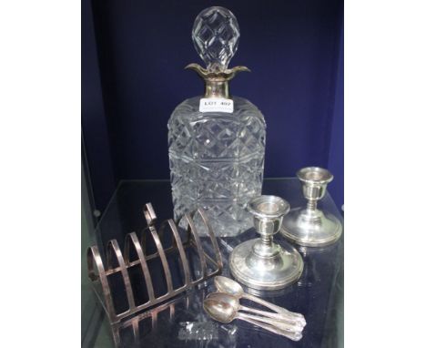 A hallmarked silver necked cut-glass decanter, together with a silver toast rack, pair of silver dwarf candlesticks &amp; a s