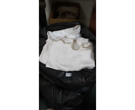 A large collection of textiles, which includes table clothes, curtains, etc