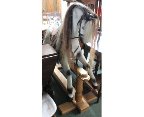 A Horse Play dapple grey rocking horse on trestle frame, with real mane &amp; tail, having leather saddlery &amp; harness