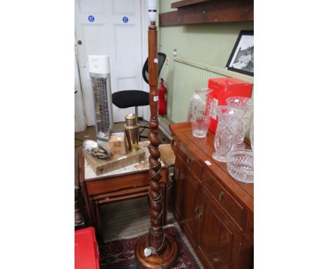 An oak standard lamp with partial barley twist stem