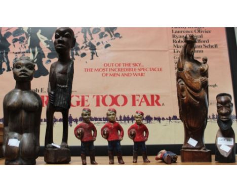 A selection of wooden figures, four young boys with rugby balls &amp; African/eastern examples