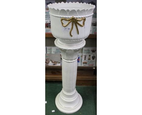 A white pottery jardini&egrave;re planter on column stand
