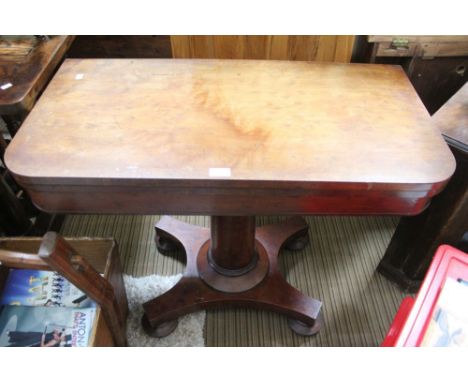 A 19th century mahogany fold-over card table, raised on turned stem &amp; platform base