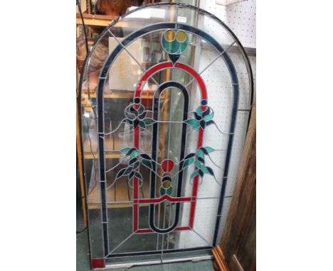 A arch top stained glass panel, 83cm x 139cm