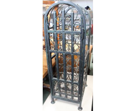 A wrought metal wine bottle store fitted portcullis gate
