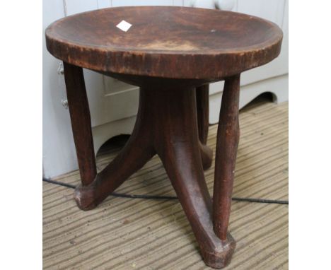 A carved Ethiopian stool with dished top, 33cm dia