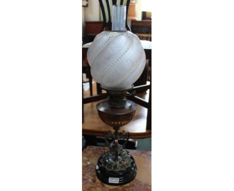 A Victorian Arts and Crafts wrought copper oil lamp, fitted wrythen opaque glass shade and clear chimney