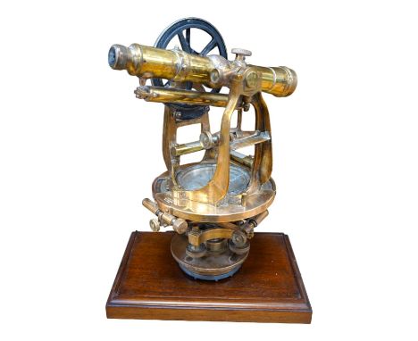 An early 20th century American brass theodolite by Keuffel and Esser Co. mounted on a mahogany base, 39.5cm high. Condition -