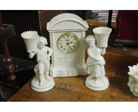 BELLEEK - A collection of 3 pieces of Belleek to include Boy Basket Bearer, Girl Basket Bearer (both A/F) & a mantle clock.