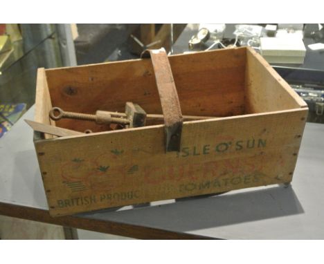 COLLECTABLES - A vintage wooden tomato crate with a selection of vintage tools to include a saw, clamps, set square etc.