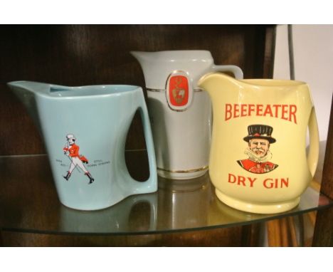 COLLECTABLES - A collection of 3 vintage ceramic advertising water jugs to include a yellow Wade 'Beefeater - Dry Gin' piece,