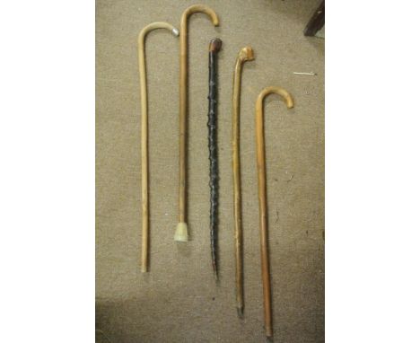 COLLECTABLES - A collection of 5 vintage walking sticks to include a blackthorn stick, a stick with small Sterling silver col