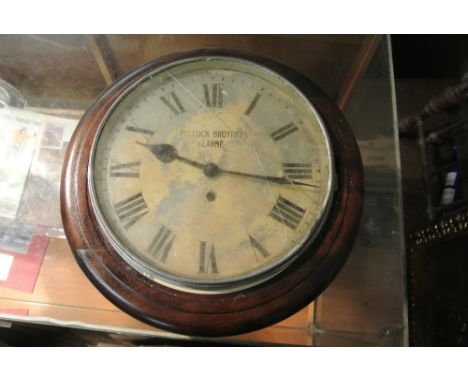 COLLECTABLES - An antique 12" office dial clock in oak case with painted dail reading 'Pollock Brothers - Larne' in need of r