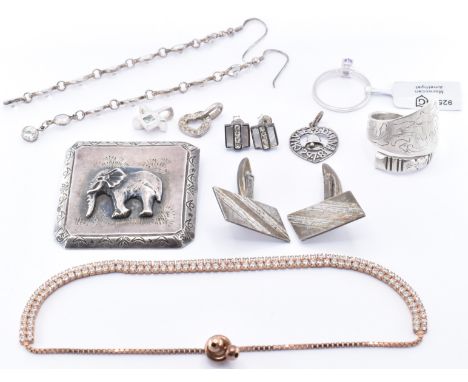 A selection of silver jewellery to include a silver and amethyst ring (size N.5), a pair of silver cufflinks, a 1950's South 