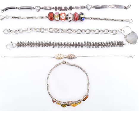 A group of silver bracelets to include a foliate design bangle set with amber cabochons, a name bracelet reading ' mum ', a s