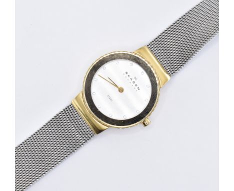A Skagen Denmark ladies stainless steel wrist watch having a round face with a yellow metal bezel and white stones to the cha