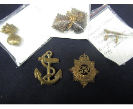 Collection of ten pieces of military insignia including Royal Navy, Torpedo Training Anchor, WWI Geo. V Royal Army Service Co