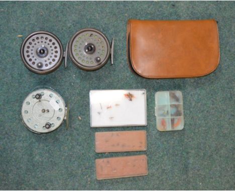 Three fly fishing reels, one vintage unbranded with ebony handles, two rim fly Intrepid King size fly reels, one leather pouc